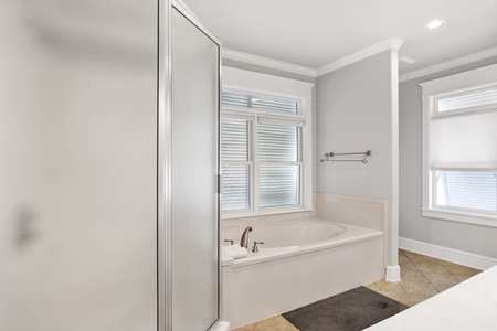 The master bath has a walk-in shower and a soaking tub