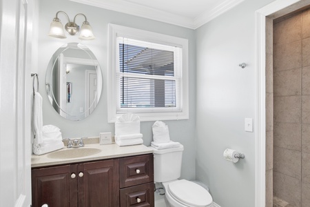 The private bathroom features a walk-in tile shower