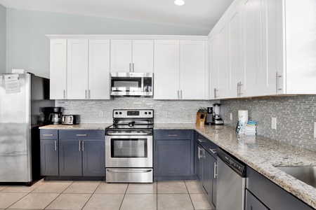 Granite countertops, stainless appliances and tile backsplash