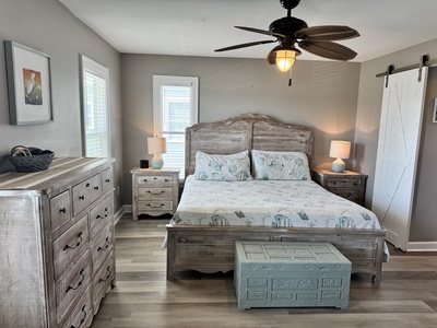 The first floor master bedroom offers balcony access and private bathroom