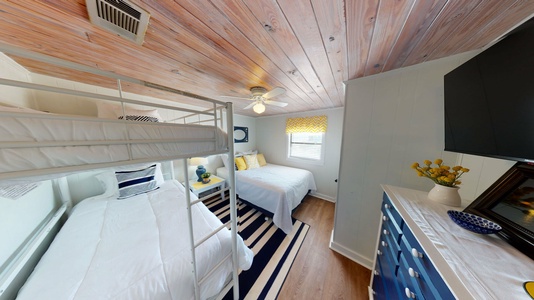 Bedroom 2 sleeps 4, queen bed and twin bunk beds, TV, shares hall bath,