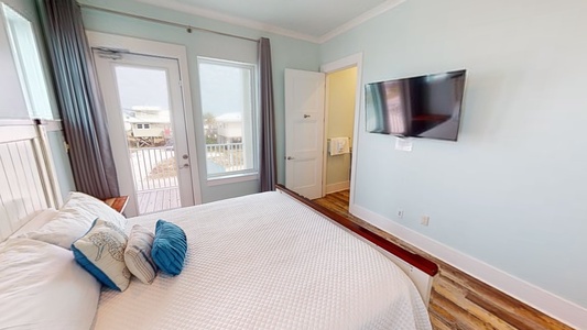 Bedroom 6 comes with a TV, balcony access and a private bathroom