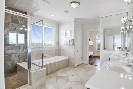Private bath in Bedroom 6 with a walk-in shower, double vanity and a soaking tub