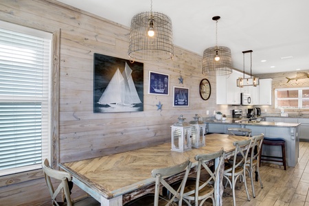 The dining table seats 10 with additional seating at the kitchen bar