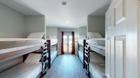 Bedroom 9 is on the 2nd floor and sleeps 8 in 4 twin bunk beds and has a TV