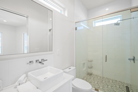 The private bathroom in Bedroom 6 has a large walk-in shower