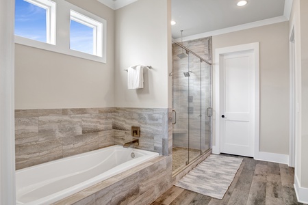 The master bath features a separate soaking tub