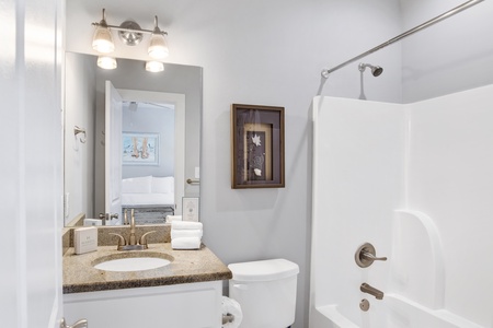 The private bathroom features a tub/shower combo
