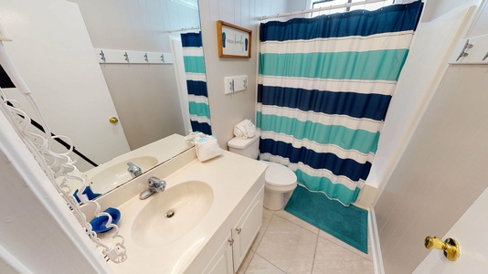 Full bath located between bedroom 3 and 4 with shower tub combo