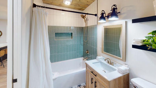 The shared hall bath features a tub/shower combo