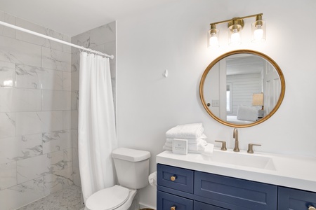 The private bathroom has a walk-in tile shower