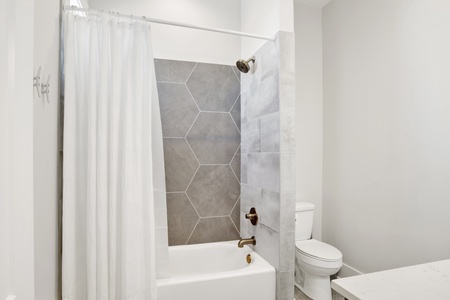The private bath for bedroom #2 has a tub/shower combo