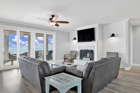 The living room offers a TV and balcony/boardwalk access