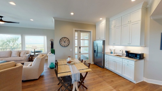 Main level kitchen table that seats 4 with a fridge and kitchenette area