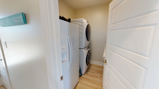 Laundry and extra refrigerator located on lower level
