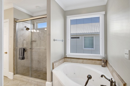 The private bath for bedroom 3 has a double vanity, walk-in shower and a soaking tub