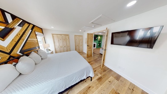 The Master bedroom features a television and a private bathroom