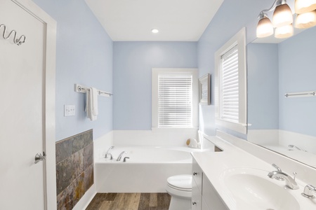 The master bathroom has a large, soaking tub and shower