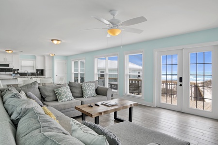 Living area features a large sectional that also doubles as a sofa sleeper for 2, TV, and access to the beach front deck