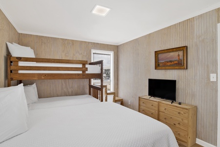 Bedroom 3 sleeps 4 guests and has a TV