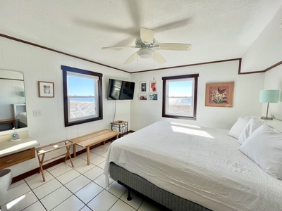 Master bedroom 1st floor with a TV and attached bath with hallway access