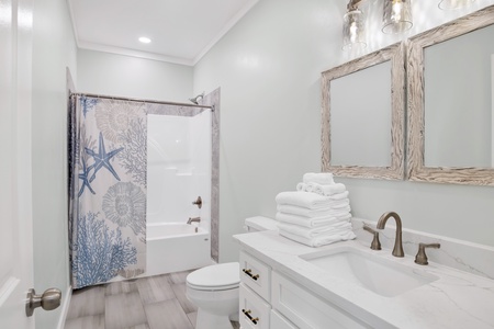 The shared hallway bathroom features a tub/shower combo