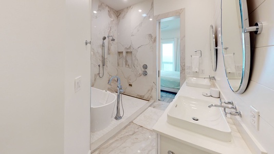 Bedroom #4 bathroom with double vanity and a soaking tub and a walk-in shower