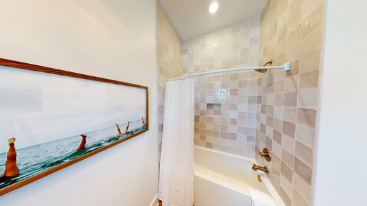 This bathroom features a tub/shower combo