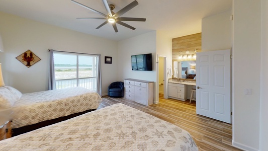 Bedroom #4 has a mounted TV, lagoon views and a ceiling fan