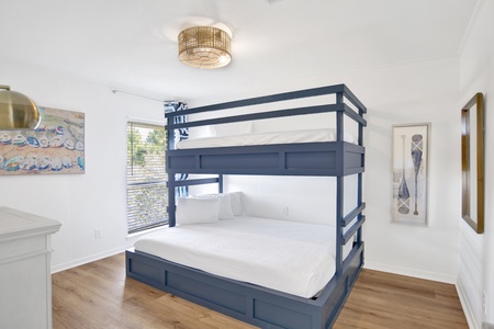 The guest bedroom has a custom Twin over Queen bunk bed, sleeps 3 guests