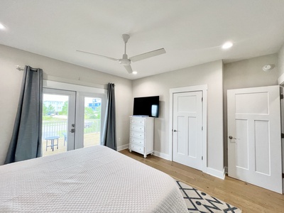 Bedroom 1 has a TV and balcony access