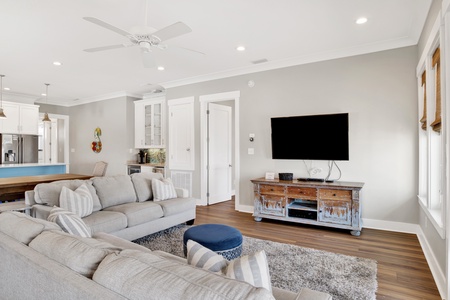The main living room has a TV and balcony access