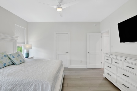 Bedroom 2 features a TV, ceiling fan and a private bathroom