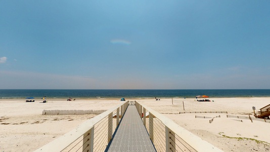 Private boardwalk that leads from the home to the beach