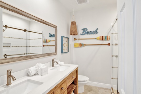 The shared hall bathroom features double vanities and a walk-in shower