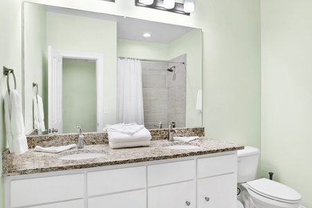 Shared hall bathroom on the 2nd floor with a double vanity and a tub/shower combo