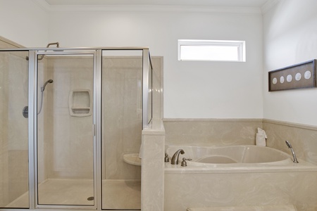 Bama Boat House North master bathroom with a walk-in shower and soaking tub