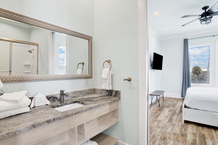 The shared Jack and Jill bathroom has a tub/shower combo
