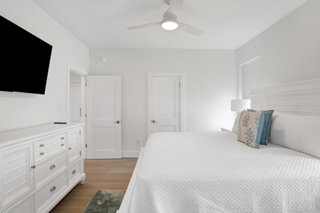 Bedroom 1 features a TV, ceiling fan and a private bathroom