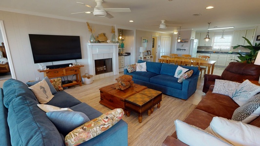 Spacious living area with 3 sofas and a TV