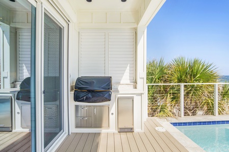 Outdoor cooking area with a gas grill and beverage cooler