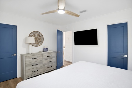 The primary bedroom has a TV and attached bathroom