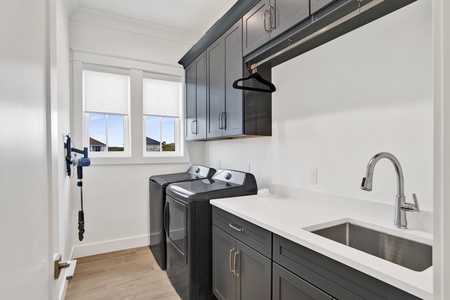 The 2nd floor laundry room has a full size washer/dryer and sink
