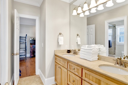 Jack-n-Jill bathroom between bedrooms 4 and 5 with a double vanity and a tub/shower combo