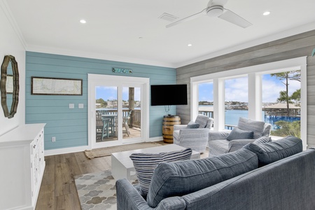 The living room has a TV and balcony access