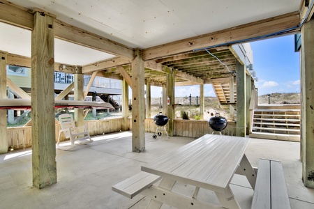 The carport offers 2 BBQ grills and a picnic table