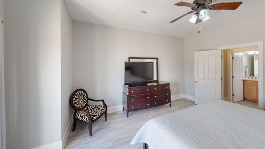 Bedroom 5 has a TV and the shared hall bath is directly across from this room