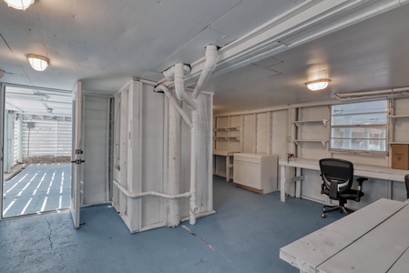 Under the carport is an enclosed area with desk space, storage and half bath