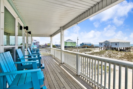 Enjoy outdoor seating under the covered porch with views of the Gulf