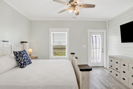 Master Bedroom 1 offers a King bed, TV and balcony access